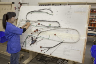 Supreme Technician working on harness assemblies