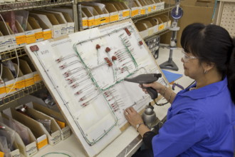 Technician working on harness assemblies