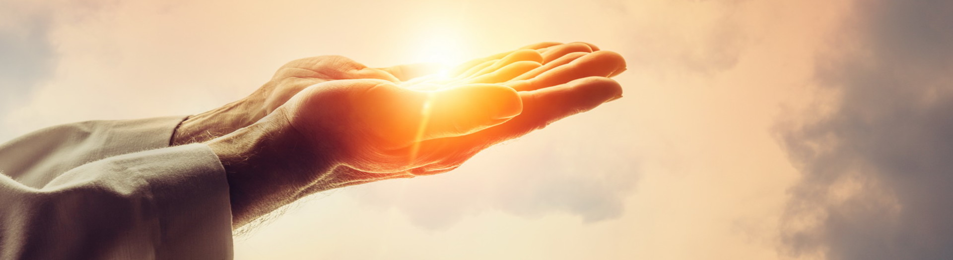 Male hands holding sunlight